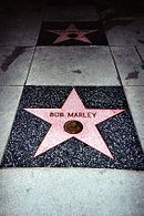 five pointed pink star inlaid in the sidewalk with Bob Marley