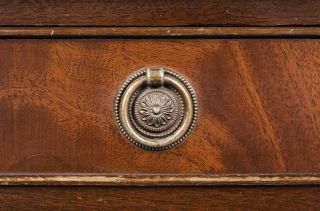 Round, brass, Edwardian style pulls adorn the drawer fronts.